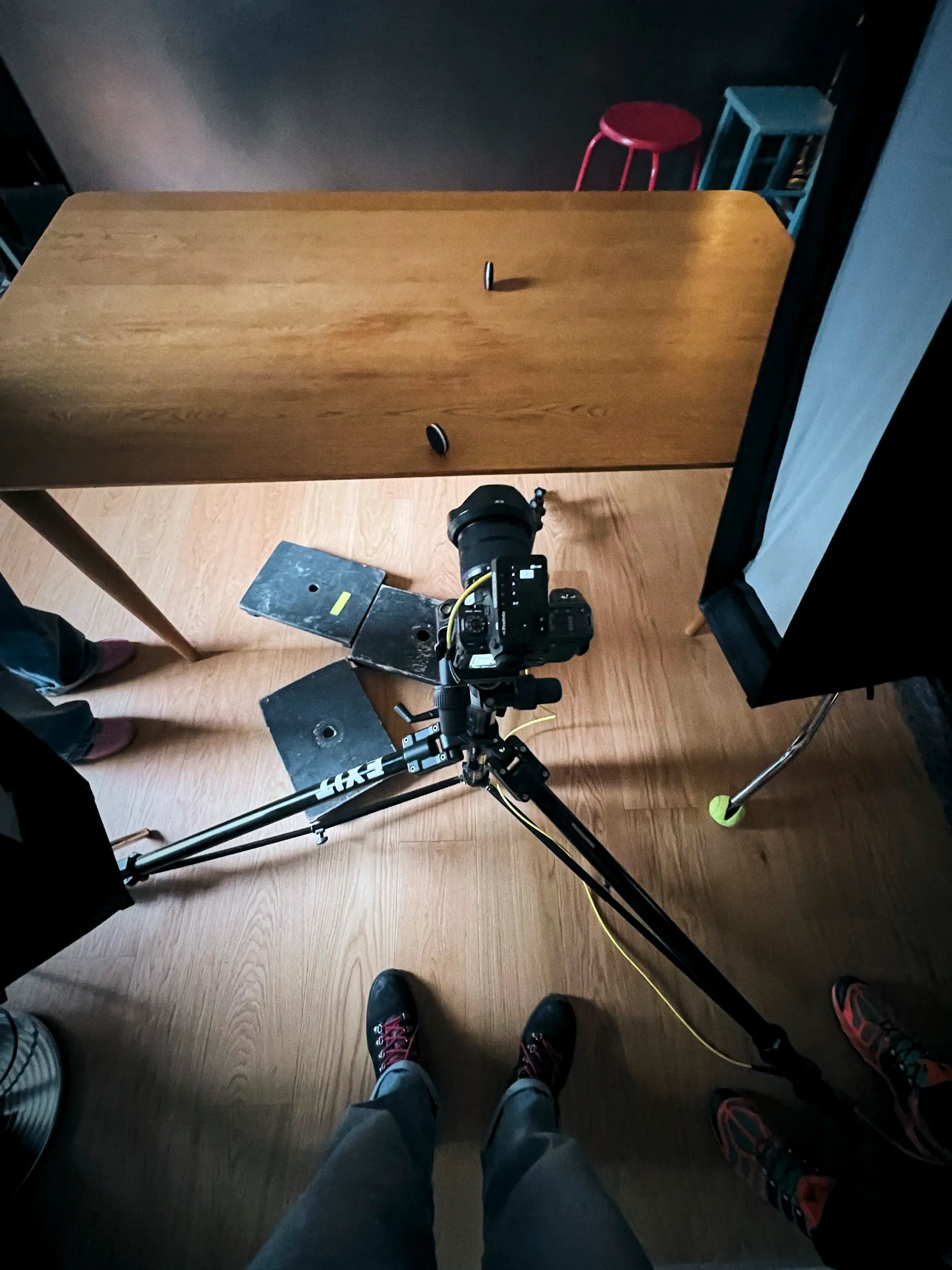 Overhead behind-the-scenes view of the camera and tripod rig set low beneath the table on the Oreo shoot.