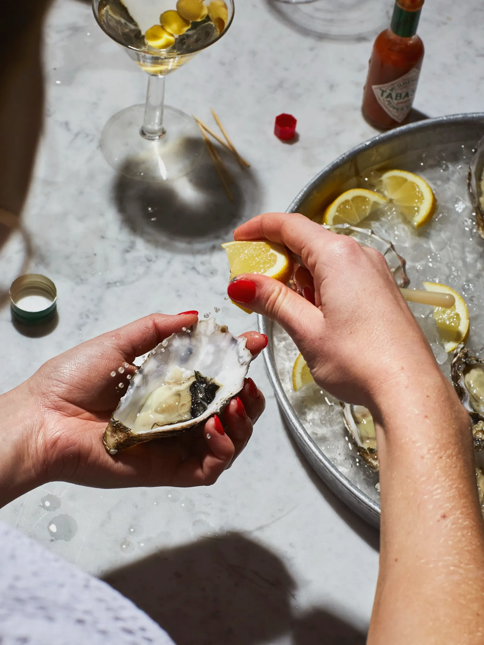 Squeezing Lemon Oysters After8